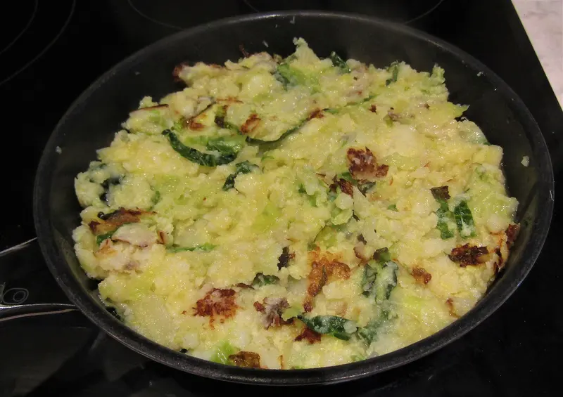 Bubble and squeak of mashed potato and cabbage frying in a pan, with crisp golden-brown patches