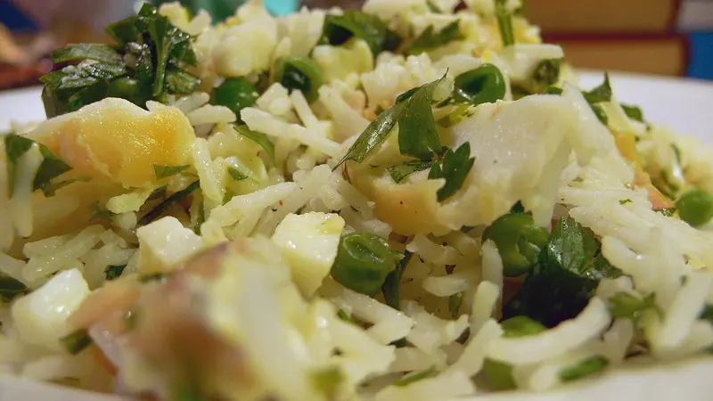 Close-up of kedgeree: rice with flaked smoked fish, chopped egg, peas and fresh parsley