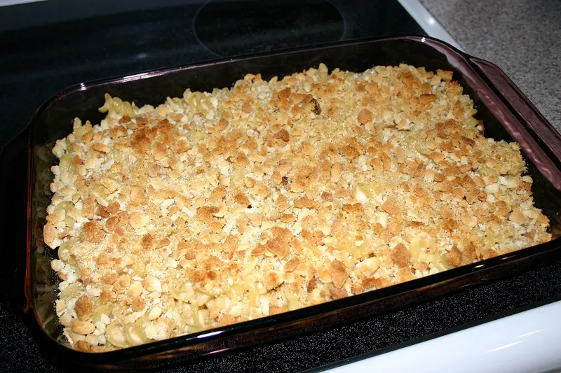 Baked macaroni cheese in a glass dish with a crunchy golden crumb topping